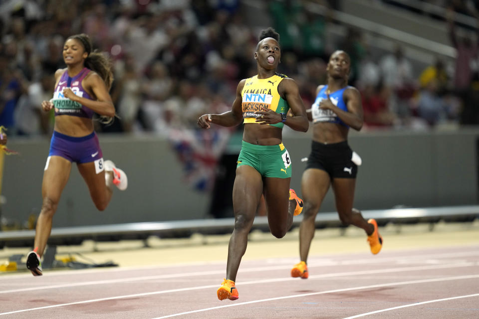 Shericka Jackson, center, of Jamaica, reacts as she wins the women's 200-meters final followed by Gabrielle Thomas, left, of the United States, during the World Athletics Championships in Budapest, Hungary, Friday, Aug. 25, 2023. (AP Photo/Ashley Landis)