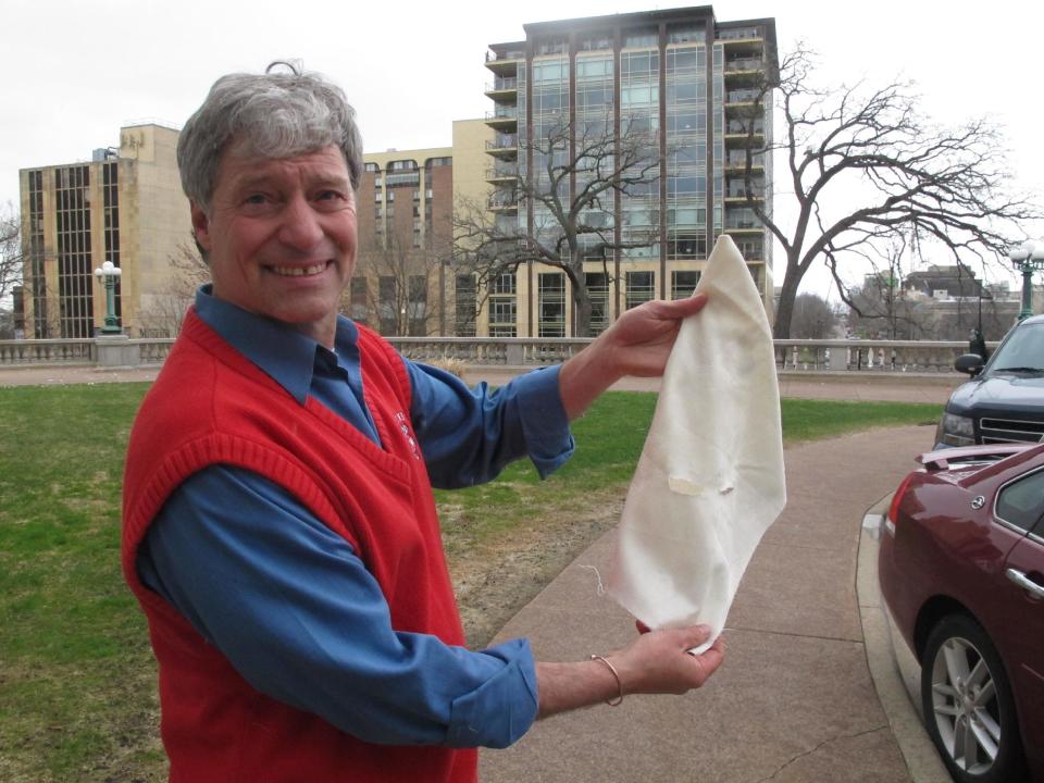 Democratic state Rep. Brett Hulsey, a candidate for governor, displays a Ku Klux Klan-style hood he sewed and plans to hand out at the Wisconsin Republican Party convention as a symbol of what he says is the GOP's racists policies on Thursday, May 1, 2014, in Madison, Wis. (AP Photo/Scott Bauer)