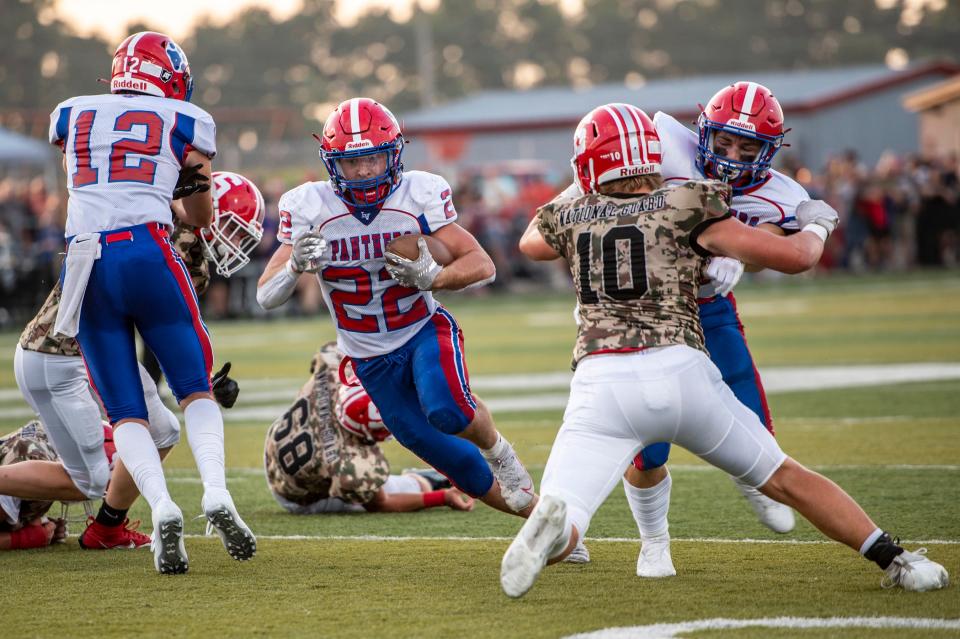 Licking Valley's Trenton Markus hits the hole during a 33-14 loss to host Sheridan at Paul Culver Stadium in the season opener on Friday, Aug. 18, 2023.