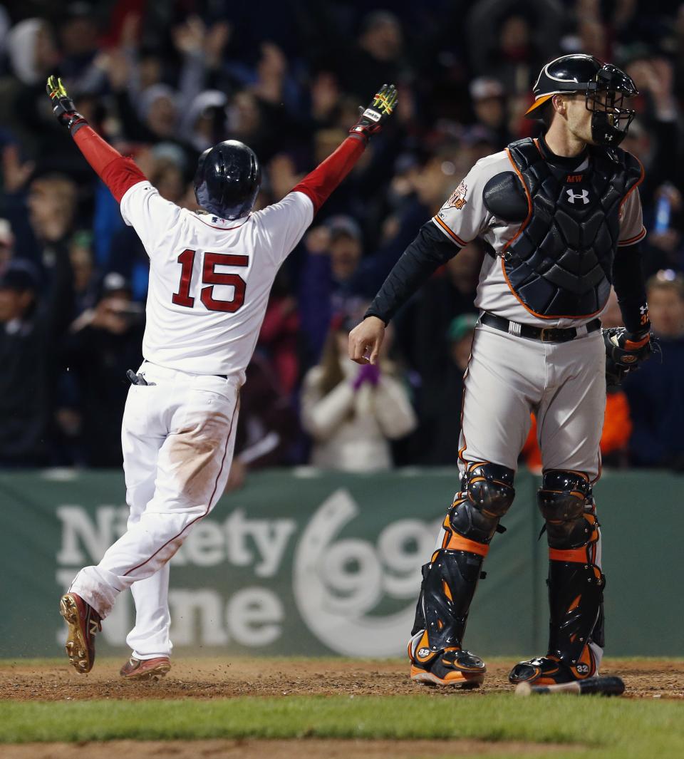 Boston Red Sox's Dustin Pedroia (15) reacts behind Baltimore Orioles' Matt Wieters after scoring on a throwing error by David Lough in the ninth inning of a baseball game in Boston, Sunday, April 20, 2014. The Red Sox won 6-5. (AP Photo/Michael Dwyer)