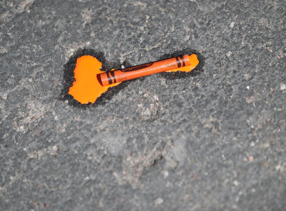 A crayon melts on scorching asphalt in Phoenix on July 22, 2023. The National Weather Service recorded a temperature of 116 degrees at Phoenix Sky Harbor at 2 p.m.