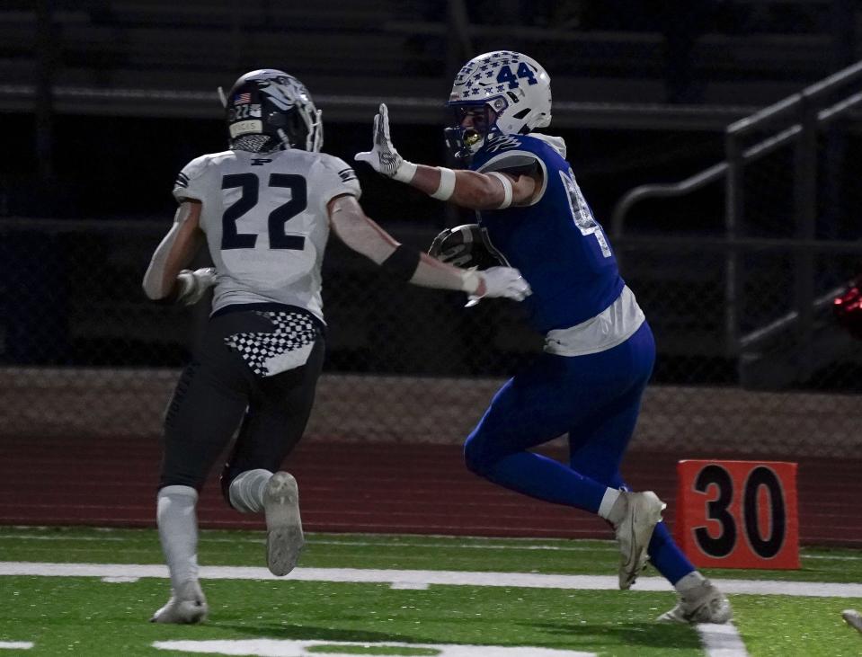 Sandra Day O'Connor's Ryan Davis (44) looks to give a stiff arm to Pinnacle's Ryan Meloche (22) during their first round 6A playoff game in Phoenix on Nov. 19, 2021.