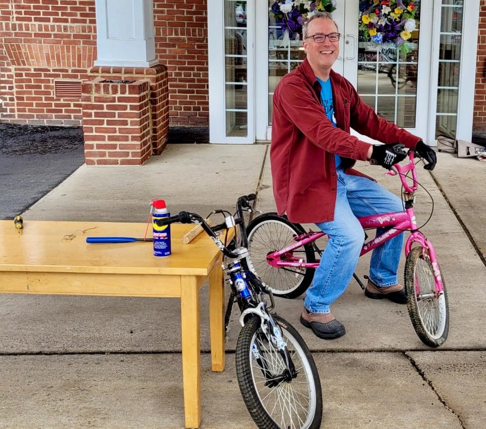 Volunteer Gregg McFarland sits on one of the bicycles donated in 2023 through Otterbein United Methodist Church's collection for Bikes for the World.