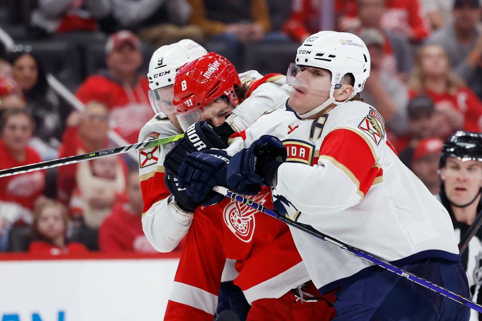 Florida Panthers center Sam Bennett and center Evan Rodrigues sandwich Detroit Red Wings defenseman Ben Chiarot in the third period at Little Caesars Arena on Saturday, March 2, 2024, in Detroit, Michigan.