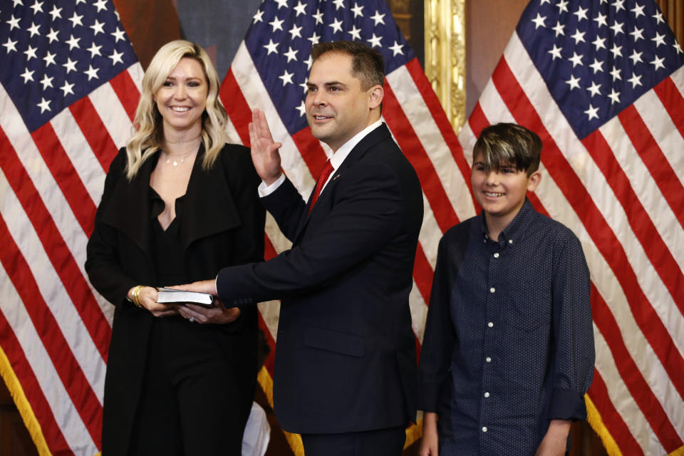 FILE - In this May 19, 2020, file photo Rep. Mike Garcia, R-Calif., center, joined by his wife Rebecca and son Preston, participates in a ceremonial swearing-in on Capitol Hill in Washington. Garcia, who in a May special election became the first Republican in over two decades to seize a Democratic-held congressional district in California, summed it up this way during his campaign: "I don't want my country to turn into what my state has become." (AP Photo/Patrick Semansky, File)