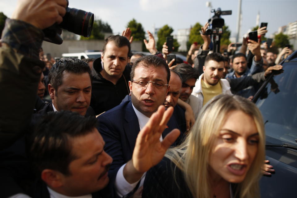 Ekrem Imamoglu, centre, of the opposition Republican People's Party (CHP) mayoral candidate in Istanbul, arrives to receive a certificate confirming his win by a slim margin against ruling party's candidate Binali Yildirim, in Istanbul, Turkey, Wednesday, April 17, 2019. Authorities have confirmed that Imamoglu won the mayoral election in Istanbul, ending nearly three weeks of recounts, although Turkey's top electoral body, has yet to consider a ruling party request for the vote in Istanbul to be invalidated. (AP Photo/Emrah Gurel)