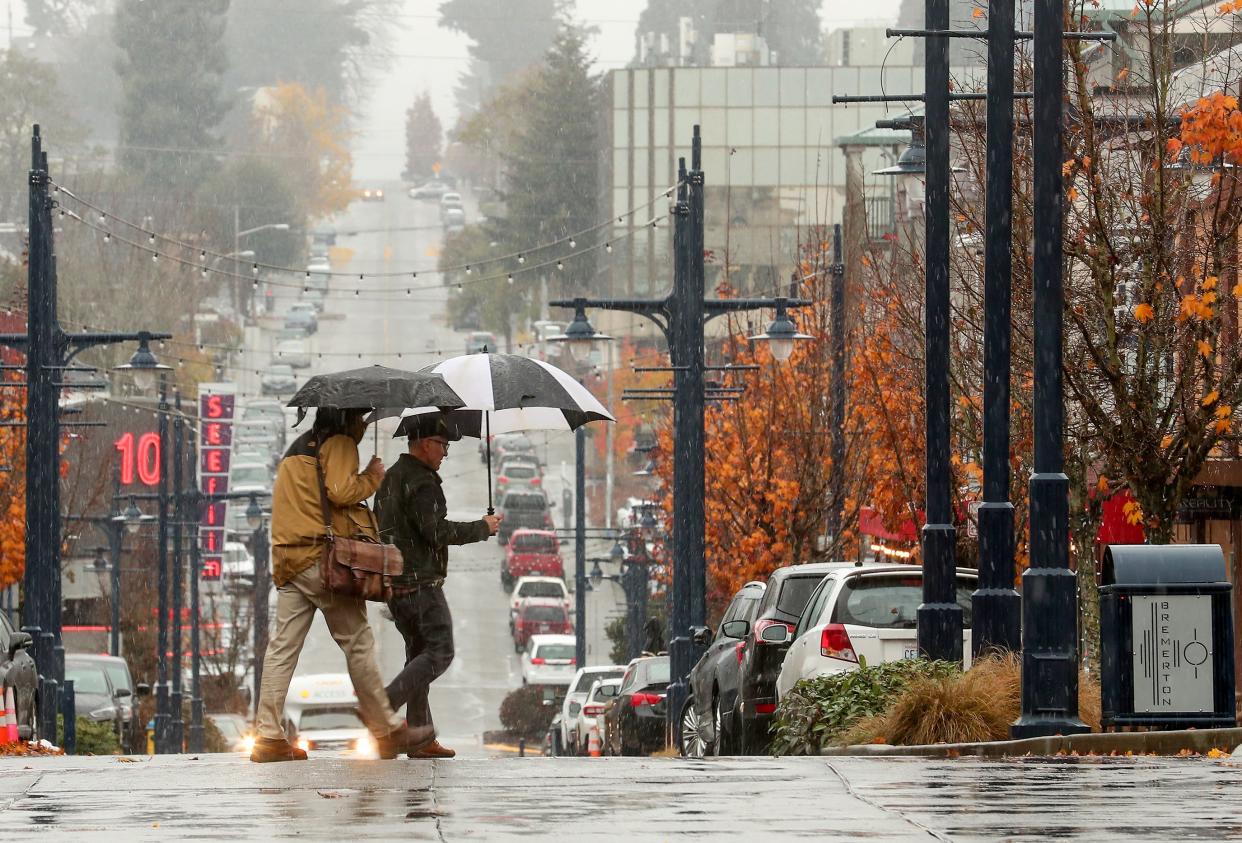 Pedestrians cross 4th Street as a wintry mix falls on downtown Bremerton on Tuesday, Nov. 29, 2022. 