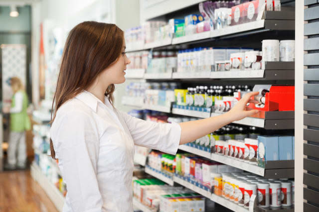 Profile shot of beautiful young woman shopping at pharmacy