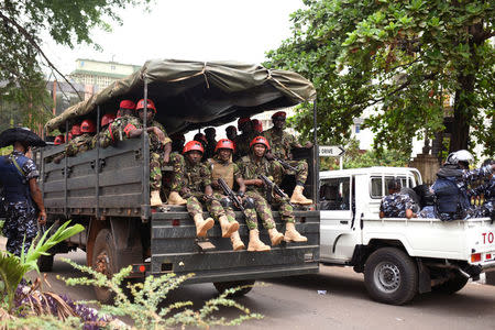 Military and security personnel are seen outside the high court in Freetown, Sierra Leone March 26, 2018. REUTERS/Olivia Acland