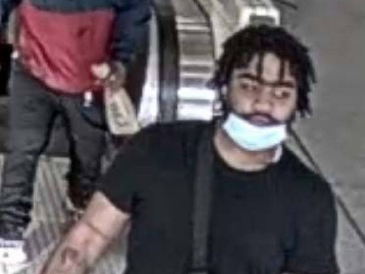 The first suspect is described as being in his early 20s, six feet tall, and as having a lighter complexion than the second suspect. He has an athletic build, short dreadlocks, thick eyebrows, a full black beard and tattoos on his left and right forearms. (Submitted by Toronto Police Service - image credit)