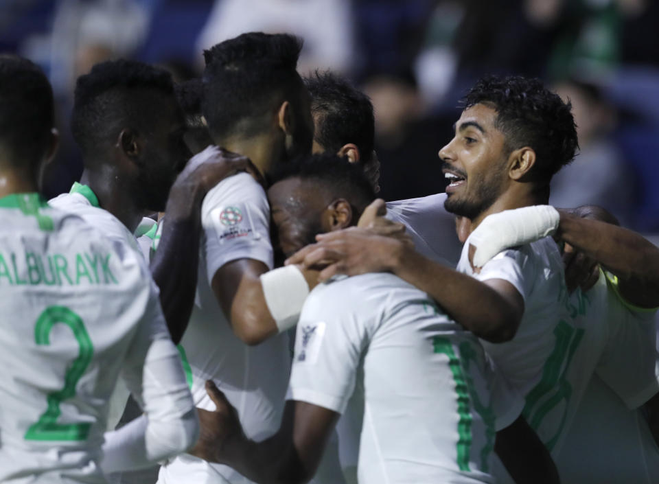 Saudi Arabia's midfielder Hussain Al-Mogahwi, right, celebrates his goal with his teammates during the AFC Asian Cup group E soccer match between Lebanon and Saudi Arabia at Al Maktoum Stadium in Dubai, United Arab Emirates, Saturday, Jan. 12, 2019. (AP Photo/Hassan Ammar)