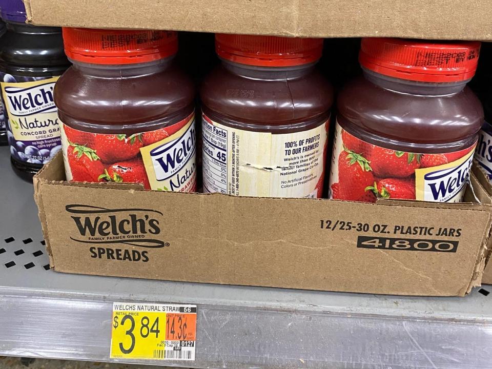 boxes filled with jars of strawberry jelly on the shelves at walmart