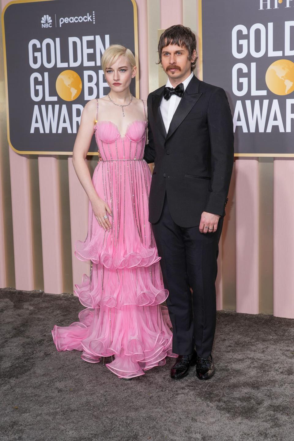 Julia Garner and Mark Foster attend the 2023 Golden Globes.