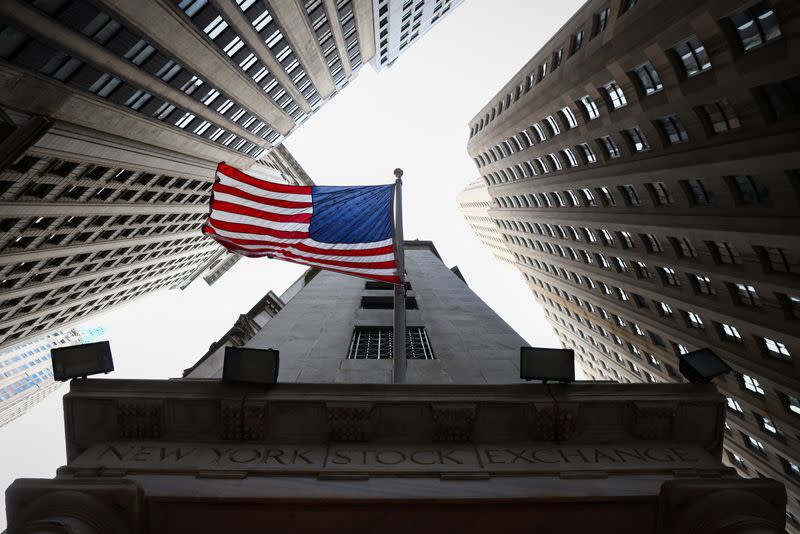 FILE PHOTO: A U.S. flag is seen outside the New York Stock Exchange (NYSE) in New York City