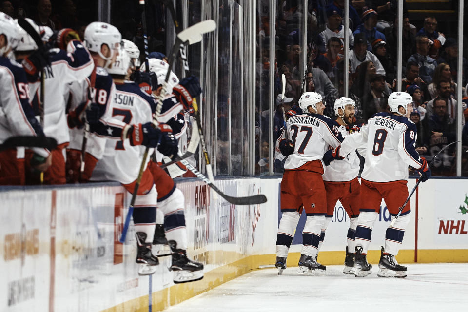 Columbus Blue Jackets' Markus Hannikainen (37) celebrates his goal with teammates during the second period of an NHL hockey game against New York Islanders, Saturday, Dec. 1, 2018, in Uniondale, N.Y. (AP Photo/Andres Kudacki)