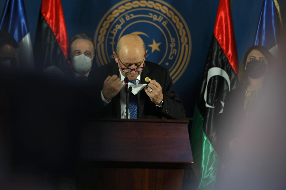 French Foreign Minister Jean-Yves Le Drian adjusts his face mask as he speaks speaks, in Tripoli, Libya, Thursday, March 25, 2021. The foreign ministers of France, Italy and Germany arrived in Tripoli Thursday, to show their support to Libya’s newly elected transitional authorities, who are expected to lead the war-stricken country through general elections end of 2021. (AP Photo/Hazem Ahmed)