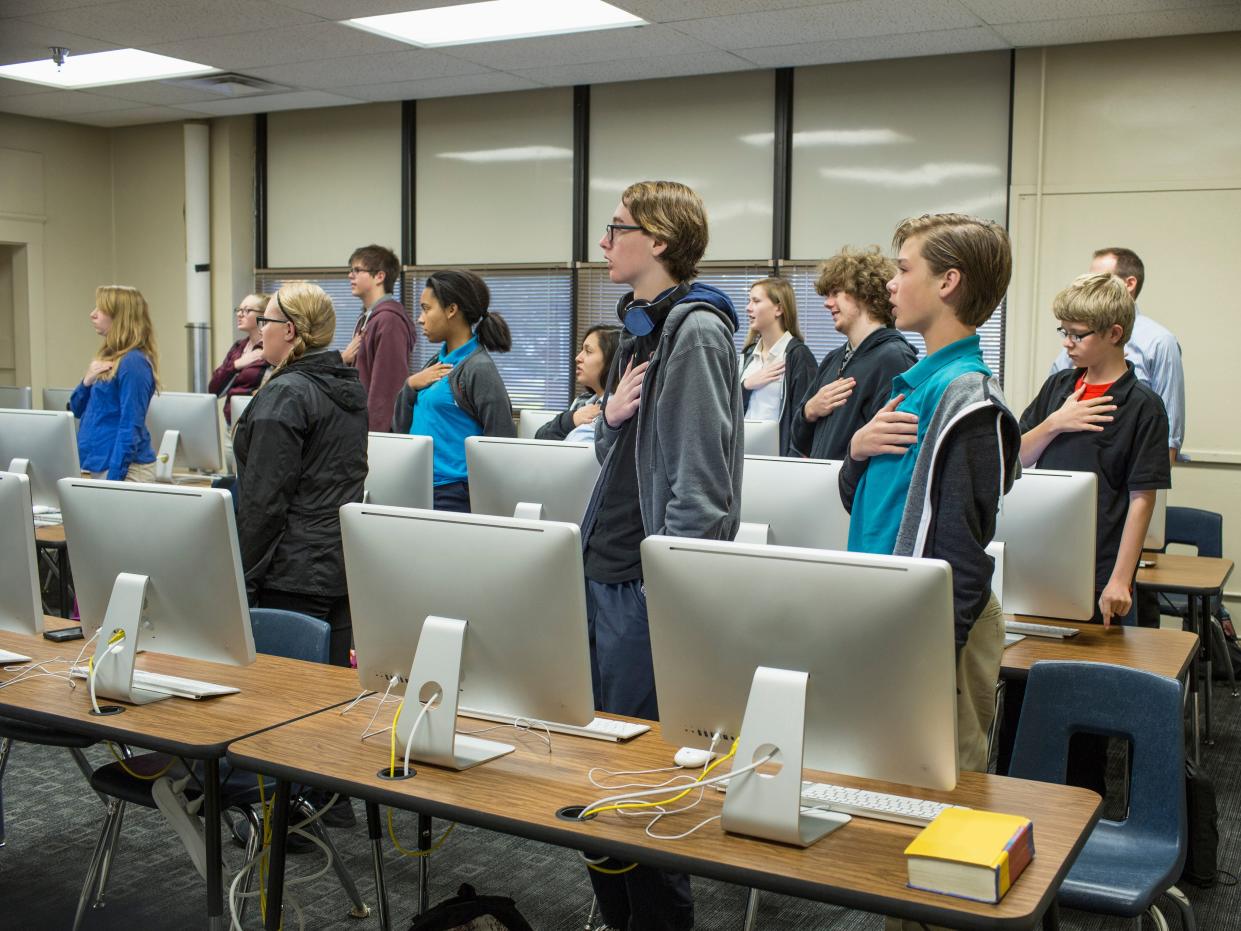 Students reciting Pledge of Allegiance in classroom