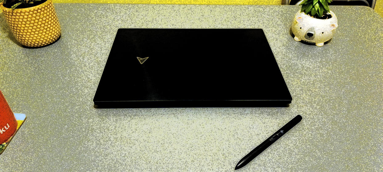  A black ASUS Zenbook Pro 16X OLED laptop on a grey table 