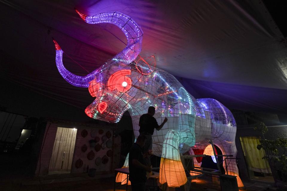 Pyrotechnic artisans create a bull of lights for the annual festival in honor of Saint John of God, the patron saint of the poor and sick whom fireworks producers view as a protective figure, in Tultepec, Mexico, Wednesday, March 6, 2024. (AP Photo/Marco Ugarte)