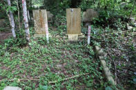 The tour guide introduces Hill 2, where many tombs are slated for exhumation.