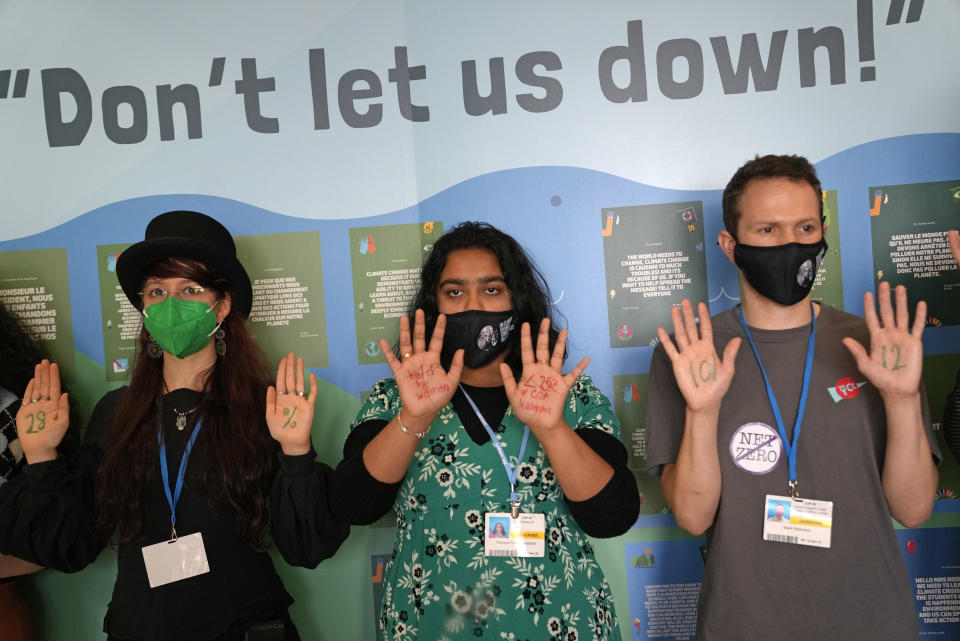 Climate activists stage a small demonstration at at the COP26 U.N. Climate Summit in Glasgow, Scotland, Tuesday, Nov. 9, 2021. The U.N. climate summit in Glasgow has entered it's second week as leaders from around the world, are gathering in Scotland's biggest city, to lay out their vision for addressing the common challenge of global warming. (AP Photo/Alastair Grant)