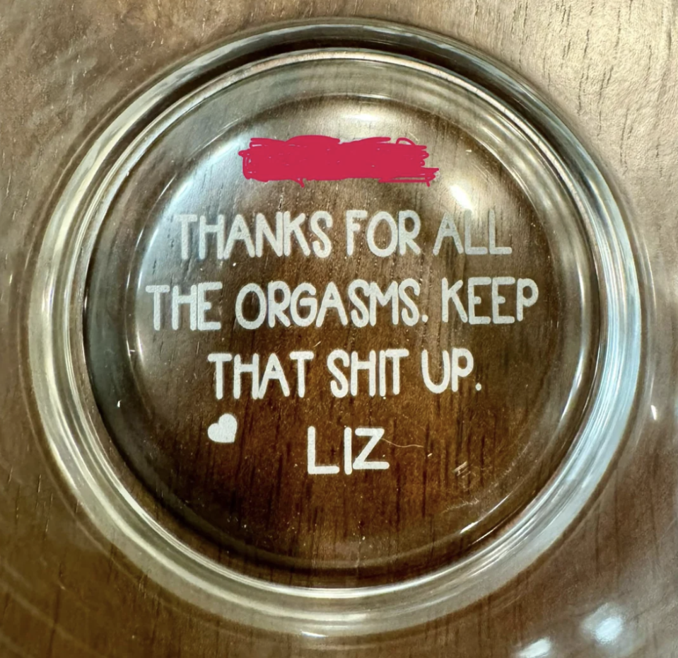 Circular glass plate with text: "Thanks for all the orgasms. Keep that shit up. ♥ Liz." Some text is redacted