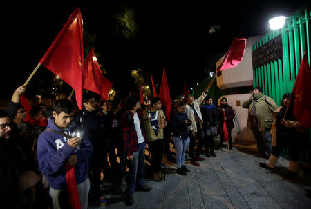 Activists and members of the Communist Party of Mexico hold up flags as they arrive outside the Cuban Embassy in Mexico, as part of a tribute, following the announcement of the death of Cuban revolutionary leader Fidel Castro, in Mexico City, Mexico November 26, 2016. REUTERS/Henry Romero