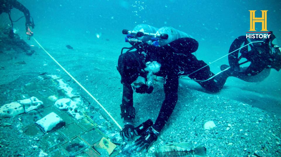 In this photo provided by The History Channel, underwater explorer and marine biologist Mike Barnette and wreck diver Jimmy Gadomski explore a 20-foot segment of the space shuttle Challenger the team discovered in the waters off the coast of Florida.