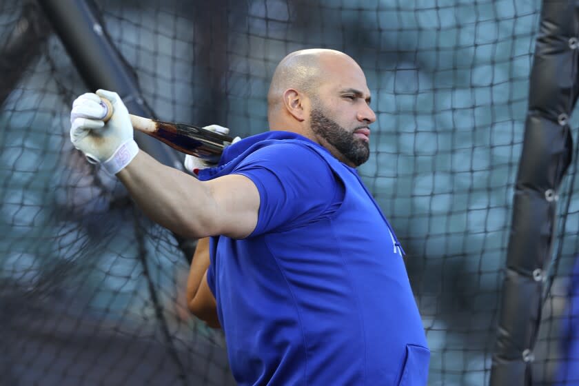 Los Angeles Dodgers' Albert Pujols warms up before Game 5 of a baseball National League Division Series.