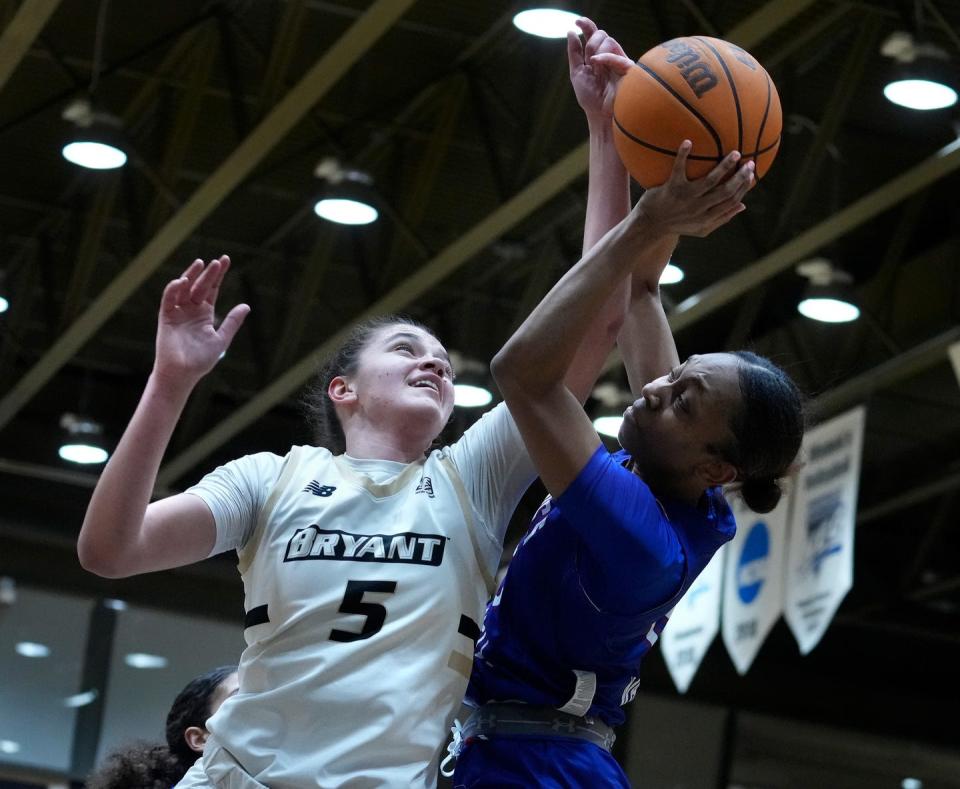 Mariona Planes Fortuny, who has committed to George Washington for next season, battles UMass Lowell's Sydney Watkins during a game at Bryant in late February.