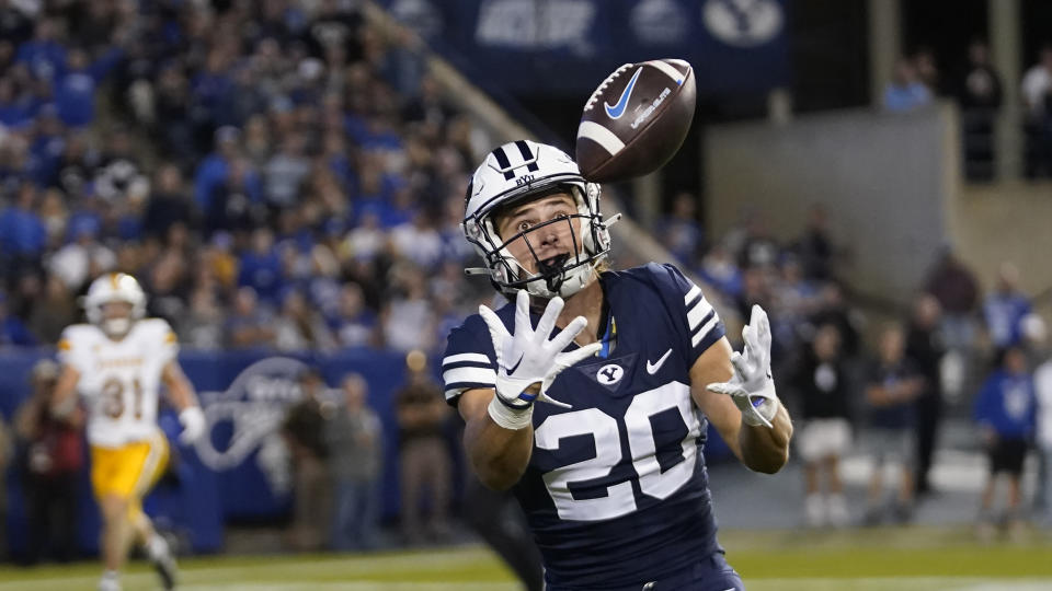 BYU wide receiver Brayden Cosper (20) reaches for a pass during the second half of an NCAA college football game against Wyoming Saturday, Sept. 24, 2022, in Provo, Utah. (AP Photo/Rick Bowmer)