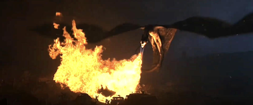 A dragon breathes fire onto the ground, engulfing it in flames during a dramatic scene from Game of Thrones