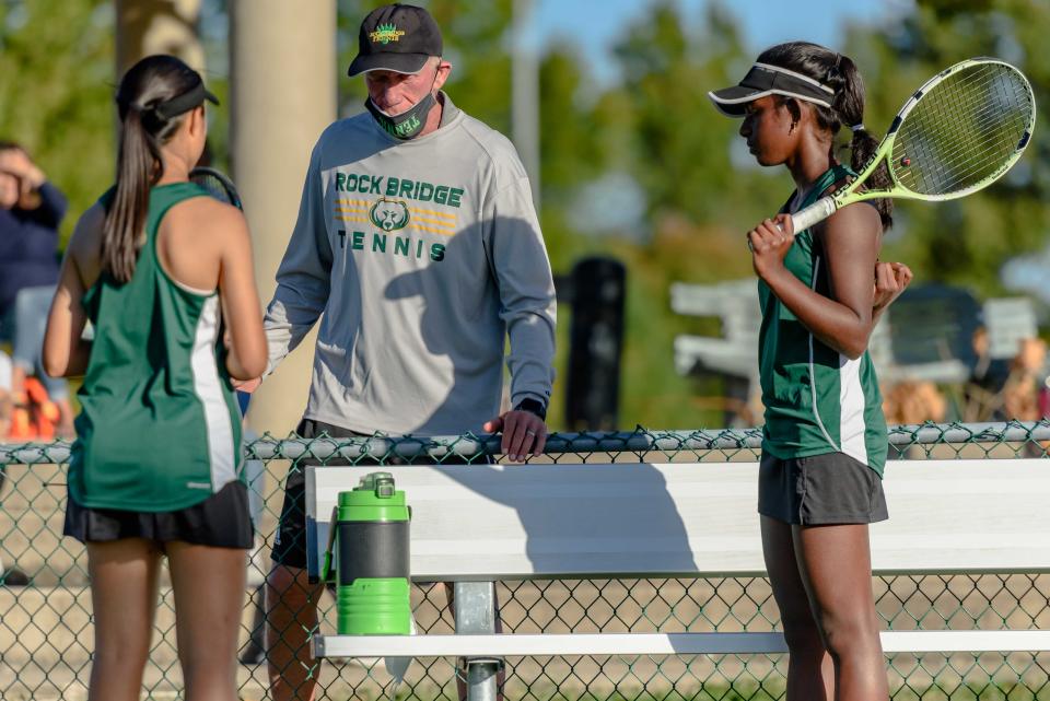 Rock Bridge head tennis coach Ben Loeb, center, talks to players Maggie Lin, left, and Anjali Ramesh during a Class 3 team sectional in 2020 at Cosmo-Bethel Park.