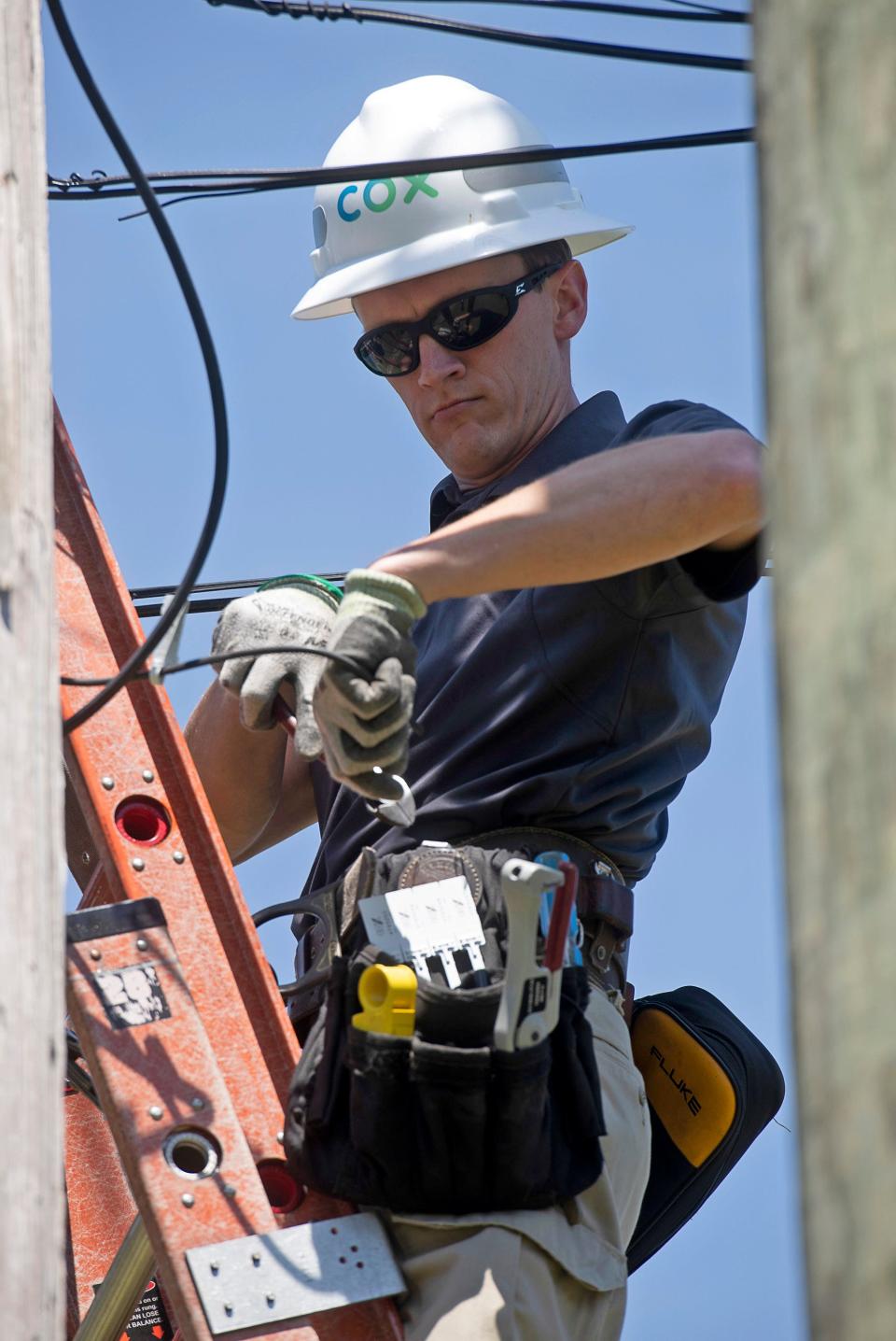 Cox Universal Home Technician Sean Tidwell performs service work on the company's internet service in the Cantonment area on April 1, 2020. As Florida works to improve internet access in small and rural communities, Santa Rosa County officials are urging all area residents to participate in a broadband speed test in late February.