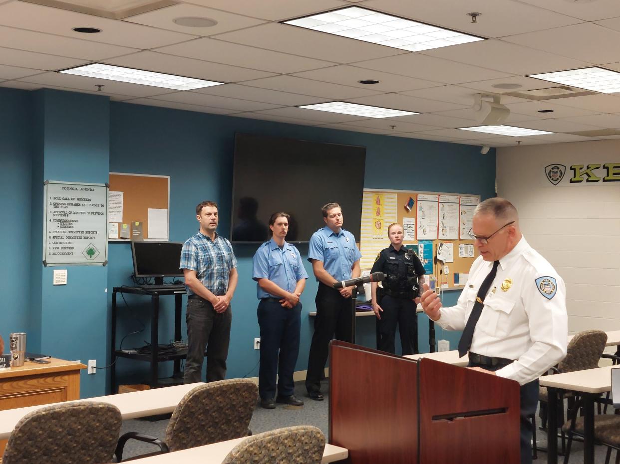 Kent Fire Chief Bill Myers, right, addresses council about the harrowing efforts of emergency personnel and kayaker Darren Bade, background left, to rescue a two-year-old from the Cuyahoga River on April 24.