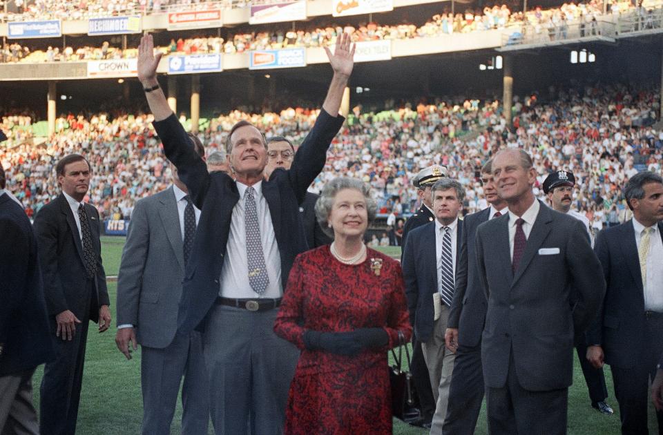 President George H. W. Bush escorts Queen Elizabeth II and Prince Philip on the field at Memorial Stadium on May 15, 1991, in Baltimore, before the Orioles played the Oakland A's.