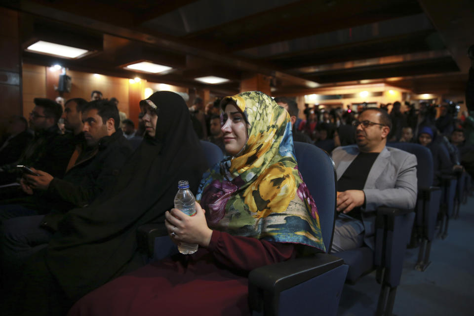 A woman weeps while a video clip is shown about an American-born news anchor working for Iranian state television's English-language service, Marzieh Hashemi, during a press briefing by Paiman Jebeli, deputy chief of Iran's state IRIB broadcaster, in Tehran, Iran, Wednesday, Jan. 16, 2019. Hashemi has been arrested after flying into the U.S., the broadcaster reported Wednesday. The reported detention of Press TV's Hashemi, born Melanie Franklin of New Orleans, comes as Iran faces increasing criticism of its own arrests of dual nationals and others with Western ties. (AP Photo/Vahid Salemi)