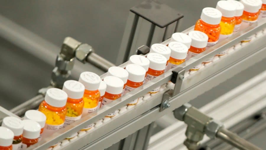 Bottles of medicine ride on a belt at a mail-in pharmacy warehouse in Florence, New Jersey. President Joe Biden’s administration has announced the first prescription drugs being targeted by the U.S. government for price negotiations as part of an effort to lower Medicare costs. (Photo: Julio Cortez/AP, File)