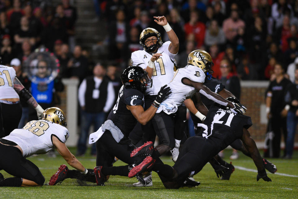 CINCINNATI, OH - OCTOBER 04: UCF (QB) Dillon Gabriel (11) tackled by Cincinnati (LB) Darrian Beavers (27) during a college football game between the University of Central Florida Knights (UCF) and Cincinnati Bearcats on October 4, 2019 at Nippert Stadium in Cincinnati, OH  (Photo by James Black/Icon Sportswire via Getty Images)