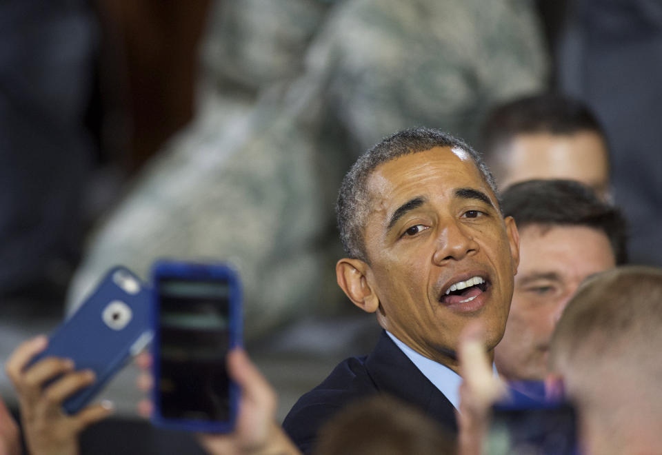 President Barack Obama greets troops after addressing an audience of armed forces December 15, 2014, at Joint Base McGuire-Dix-Lakehurst, New Jersey. Obama thanked the troops for their service and marked the end of the combat mission in Afghanistan.