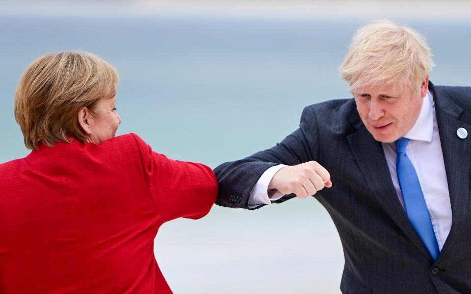 Boris Johnson with Angela Merkel at the G7 summit in Cornwall on Friday - EPA