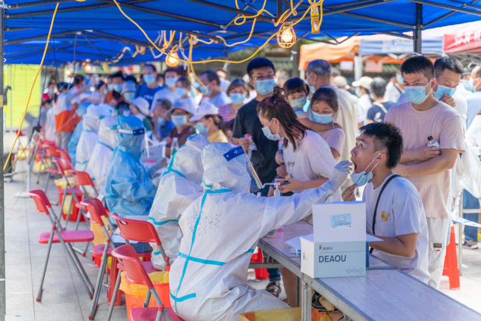 Local citizens line up on the road side for Covid-19 test at Xinghua Community of Chongkou Street in Liwan District, Guangzhou City. Source: ChinaImages/Sipa USA