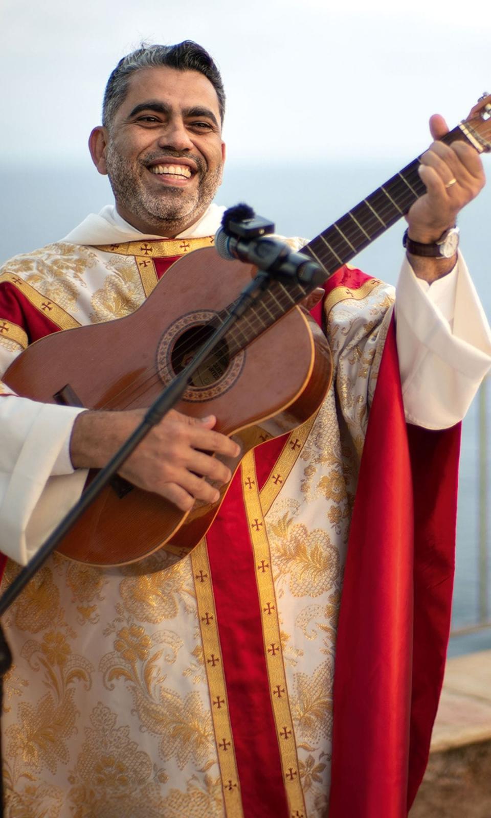 El sacerdote tocando la guitarra en la boda de Jordi Cruz y Rebecca Lima