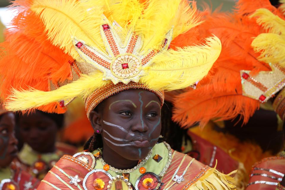 A performer walks through the street during Lagos Carnival in Lagos, Nigeria, Monday, April 1, 2013. Performers filled the streets of Lagos' islands Monday as part of the Lagos Carnival, a major festival in Nigeria's largest city during Easter weekend. (AP Photo/Sunday Alamba)