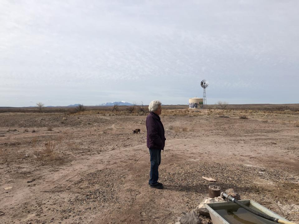 Shanna Yazzie's 79-year-old mother stands by the nearby windmill pump the family relies on for bathing water.  (Photo: Courtesy of Shanna Yazzie)
