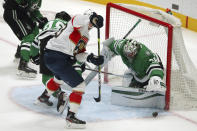 Dallas Stars defenseman Roman Polak (45) and goaltender Anton Khudobin (35) defend against Florida Panthers right wing Juho Lammikko (83) during the first period during an NHL hockey game Tuesday, April 13, 2021, in Dallas. (AP Photo/Richard W. Rodriguez)