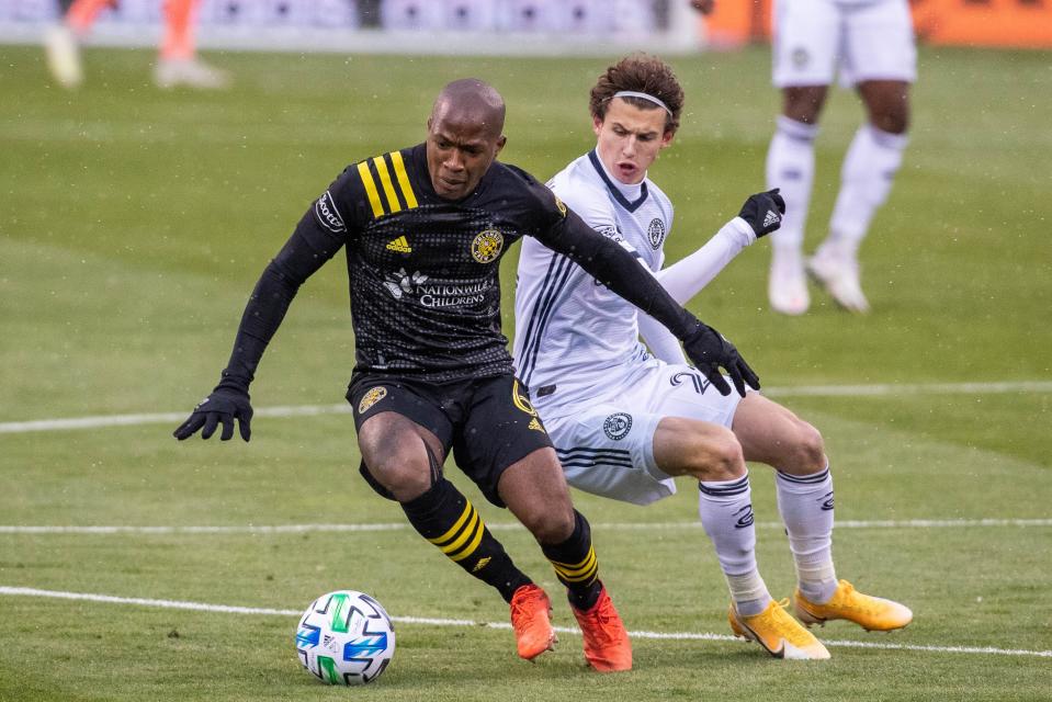 Columbus Crew SC midfielder Darlington Nagbe (6) dribbles the ball while Philadelphia Union midfielder Brenden Aaronson during a game on Nov. 1.