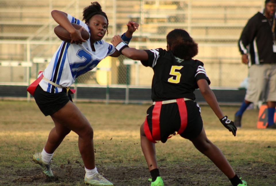 Stanton's Courtney Brown (26) tries to dodge the flag pull of Ed White's Tyra Pierce (5) during the Gateway Conference high school flag football championship in 2023.