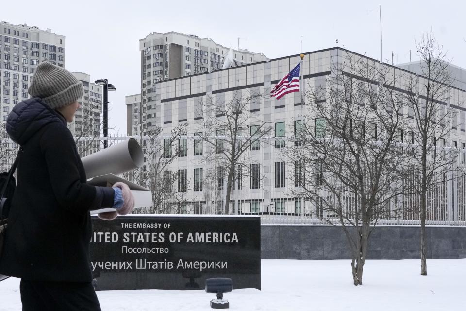 A woman walks past the U.S. Embassy in Kyiv, Ukraine, Monday, Jan. 24, 2022. The State Department is ordering the families of all American personnel at the U.S. Embassy in Kyiv to leave the country and allowing non-essential staff to leave Ukraine.  / Credit: Efrem Lukatsky / AP