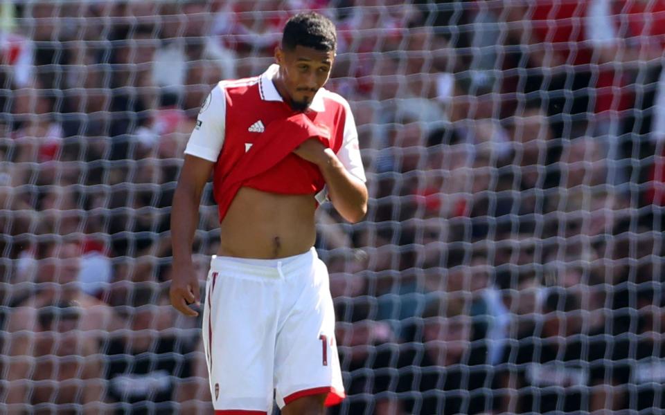 Arsenal's French defender William Saliba reacts after scoring an own goal during the English Premier League football match between Arsenal and Leicester City - Adrian Dennis/AFP via Getty Images